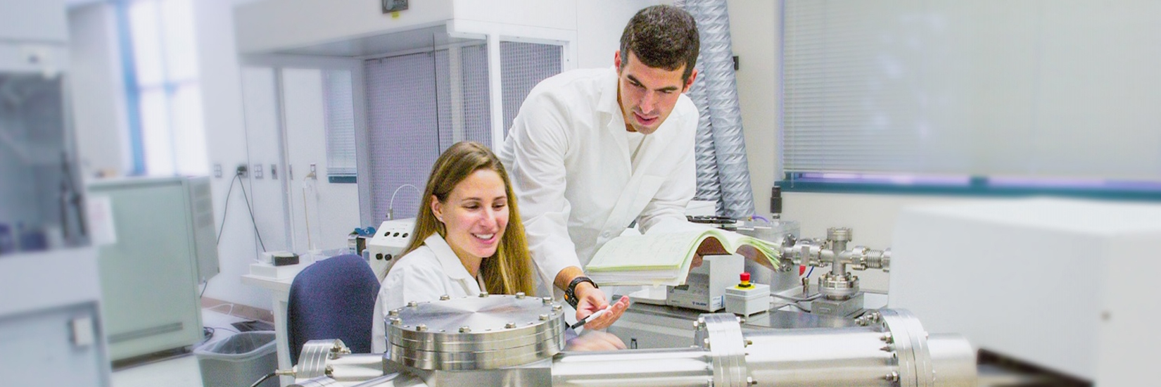 A student and professor working in a lab